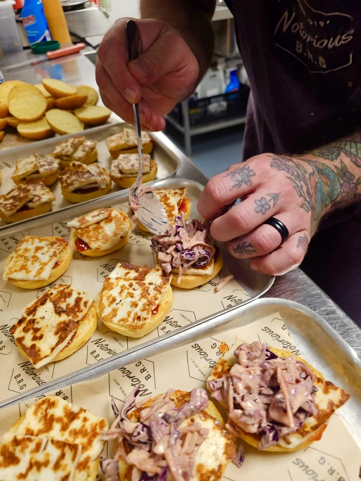 Chef finishing halloumi sliders with slaw by hand for a private event in Kent