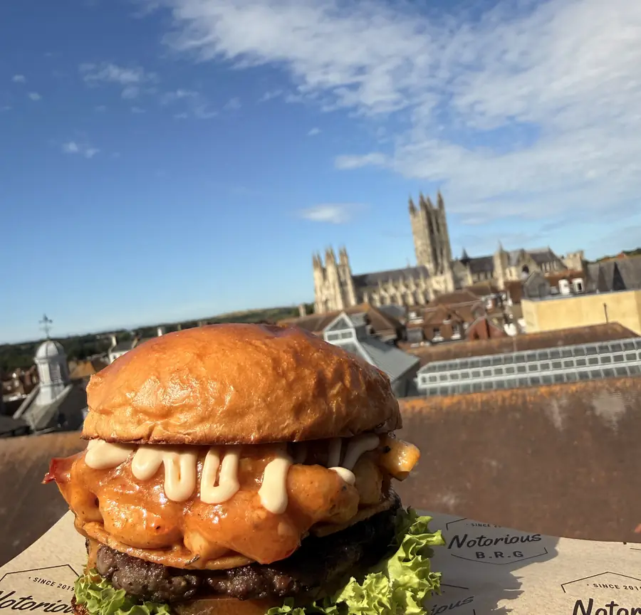 Burger on The Rooftop terrace with Canterbury Cathedral behind
