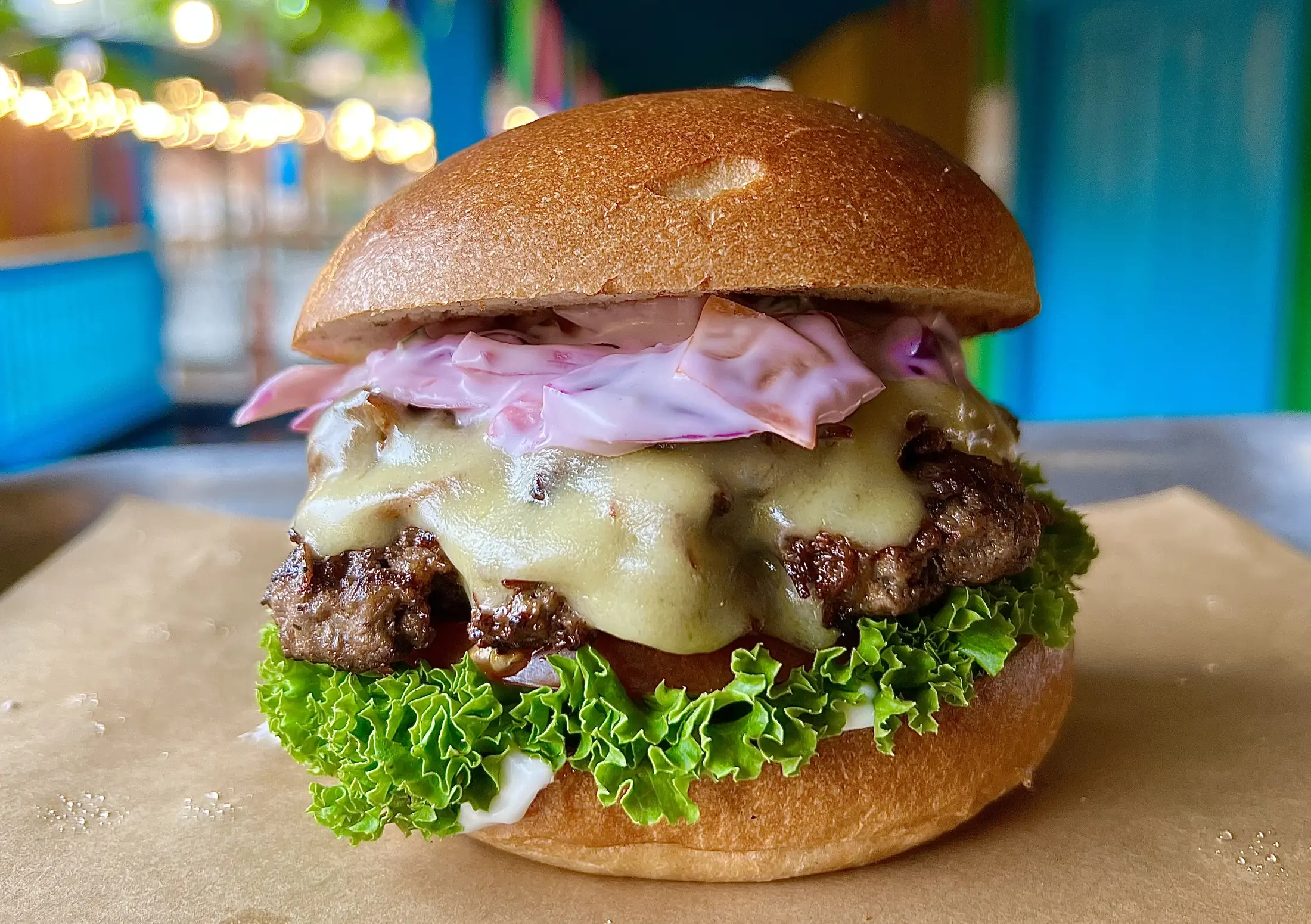 The Notorious P.I.G: beef patty, melted cheddar, house slaw and lettuce in a brioche bun